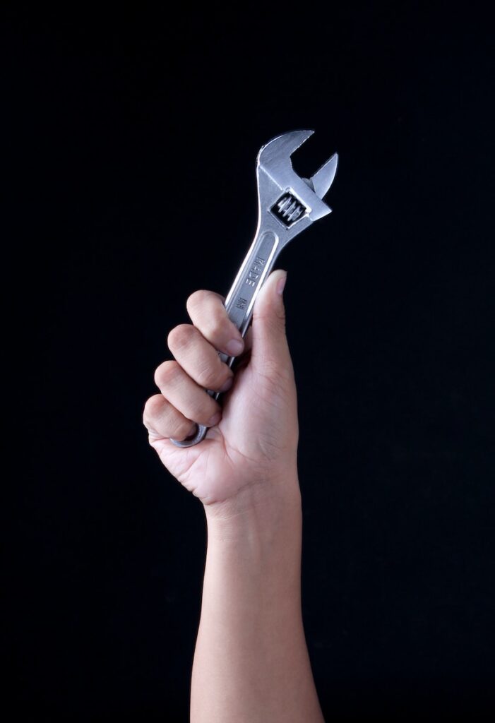 person holding gray and black metal tool